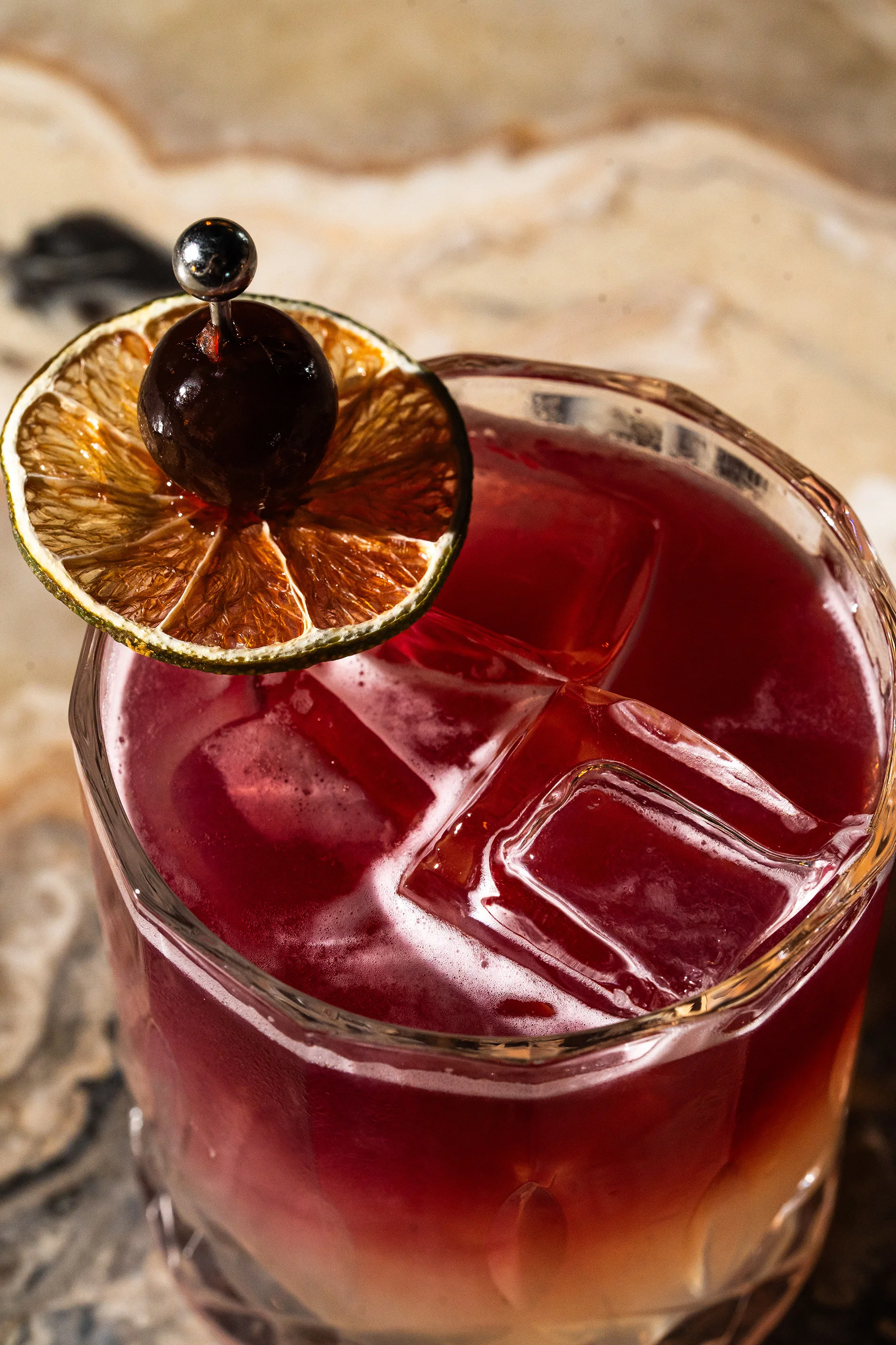 Red cocktail with cherry