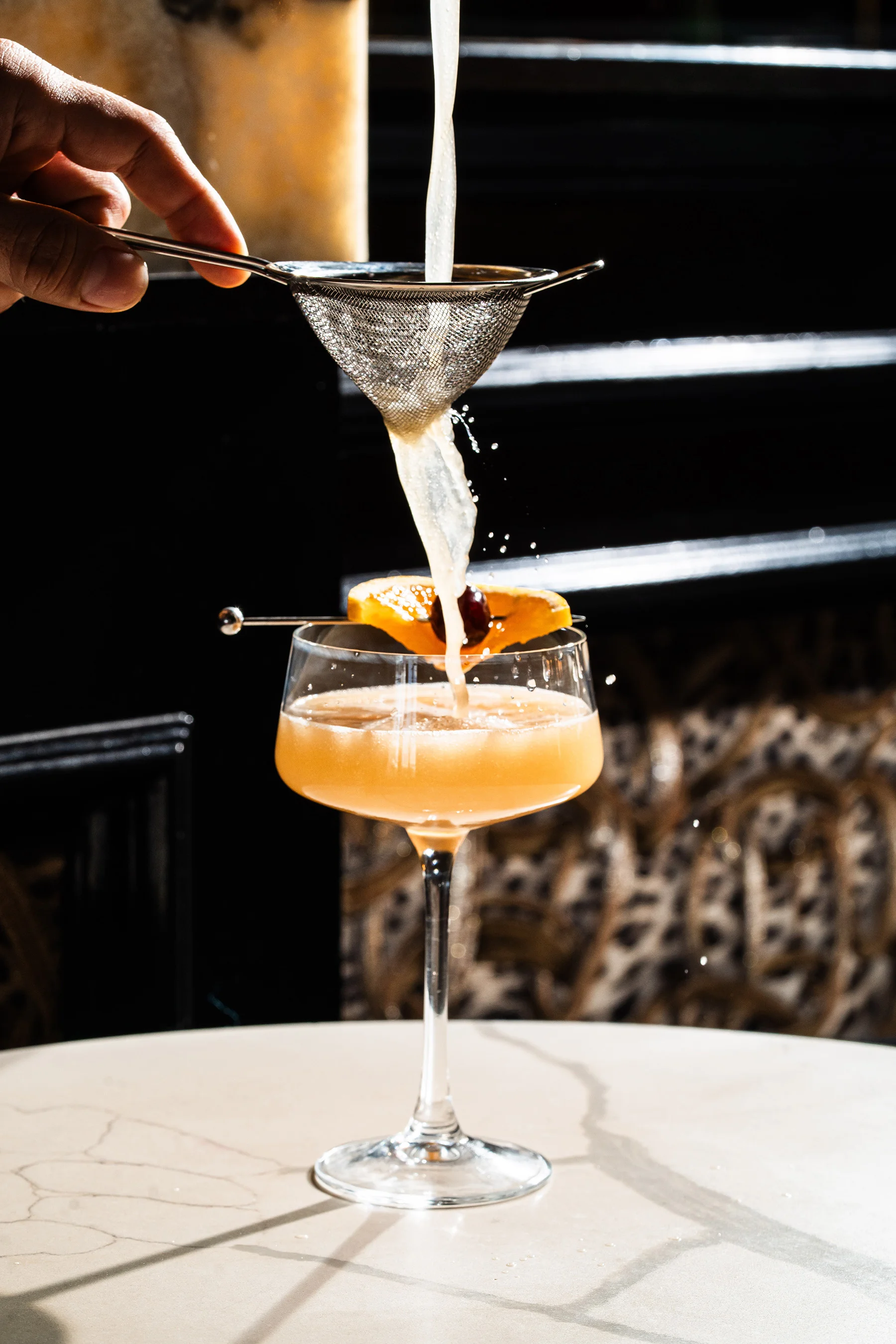 Cocktail being strained